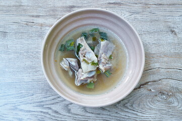 boiled  pork bone in clear soup on bowl