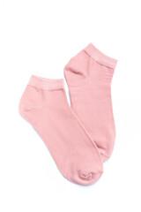 Pair of pink short socks on white background, top view