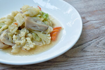 stir fried mixed vegetable cauliflower baby corn cabbage with carrot couple straw mushroom and pork on plate