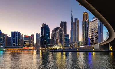 Fototapeta na wymiar Downtown Dubai modern cityscape skyline view from the Marasi marina in the Business Bay at sunset in the United Arab Emirates
