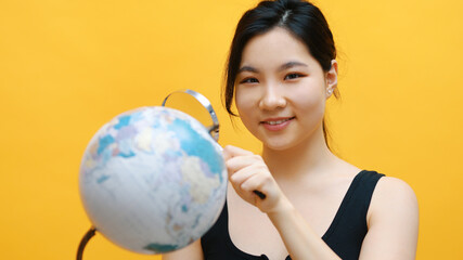 Young asian woman spy, holding globe and magnifying glass . Investigation and inspection. High quality photo