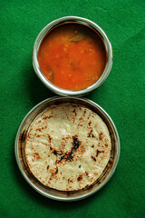 Fresh Homemade Indian Corn Bread with spicy black gram pulse recipe. Makki ki Roti And Urad Dahl. - obrazy, fototapety, plakaty