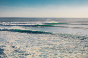 Obraz premium Big and long waves in ocean. Ideal swell for surfing