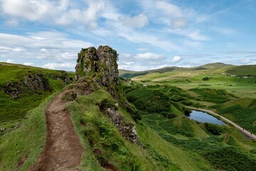 The rocks of Faerie Castle (Castle Ewen) at the Fairy Glen in Isle of Skye in Scotland with a muddy path