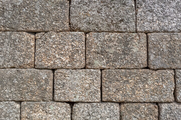 Detail view of a stone texture in detail of rustic granite wall, typically used on portuguese architecture