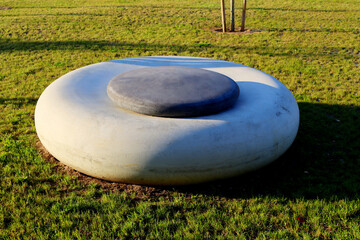 Large flat gray and black stones for relaxation and meditation in a green city park