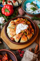Muslim Ramadan iftar family dinner. Flat-lay of people feasting over table with Middle East food. Dates, dolma, kebab, flatbread, pide, borek, sweet, salad, top view. Ramazan fasting Turkish cuisine.