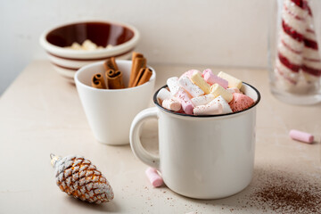 Close up of Christmas hot chocolate with marshmallow on light surface