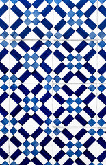 Portuguese traditional tiles Azulejos with blue geometrical pattern on a white background.