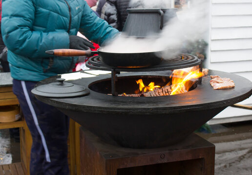 street food. cooking meat on a cone grill