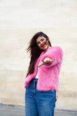 young cute girl teenager in pink fur coat gesturing hanging around outdoor , lifestyle people concept