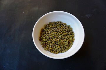 Mung beans, or scientific name Vigna radiata on the background of dried green beans. Protein-rich vegetarian food. Healthy food concept.