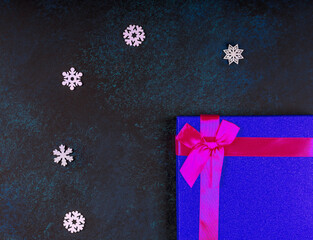 Beautiful dark Christmas background. Gift wrap. Snowflakes. Close-up. Top view.