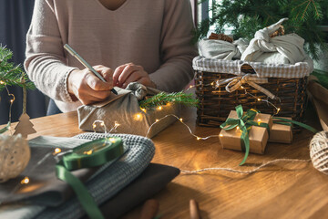 Christmas gifts. New year and gift wrapping, zero waste furoshiki, eco friendly gift wrapping in kraft paper on eco christmas background, eco christmas holiday concept, banner with eco decor