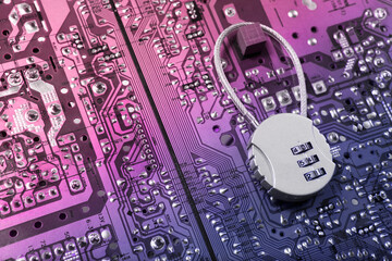 Security cipher padlock on computer circuit board.