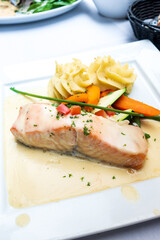 Grilled salmon and lemon - french cuisine dish with tomato and salmon