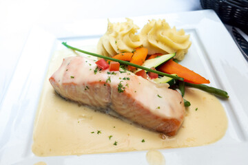 Grilled salmon and lemon - french cuisine dish with tomato and salmon