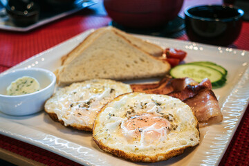 Grilled toasts served with beans, scrambled eggs and sausage for an English breakfast