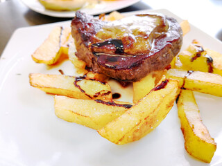 Juicy steak, beef meat with tomato and french fries