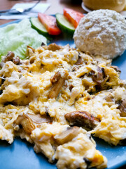 Omelet cooked with tomatoes and chives prepared with fresh lettuce as side dishes for a healthy vegetarian breakfast ready to be served