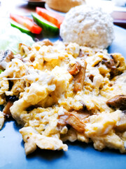 Omelet cooked with tomatoes and chives prepared with fresh lettuce as side dishes for a healthy vegetarian breakfast ready to be served