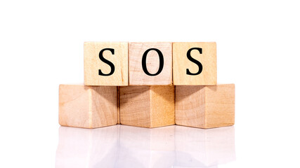 The word SOS is written on the cubes, wooden cubes