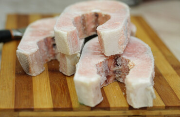Frozen salmon raw red fish steak on the table