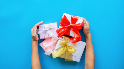 Female hands hold few gift boxes