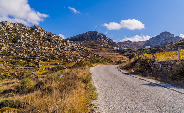 A road and rocky landscapes in the foothills of Mount Exomvourgo on the island of Tinos, Cyclades, Greece