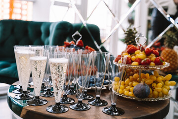 Wine glasses filled with champagne on the buffet table
