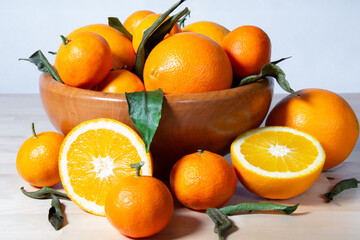 Some oranges in a basket over a wooden surface