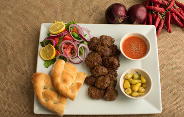 Top view of meatballs served on a white plate.