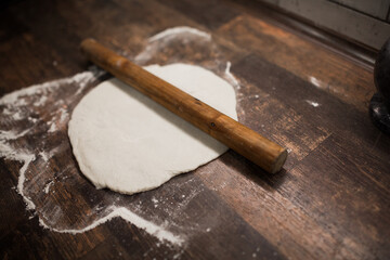 dough rolled out for pizza on the table