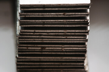 Stainless rusty steel tin metal sheets in stack on industrial plant. Heavy metal industry concept.