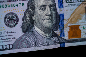 Selective focus on detail of 100 dollars banknote. Close up macro detail of money banknotes,...