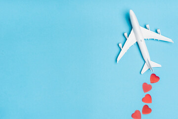 top view of plane model and red hearts on blue 