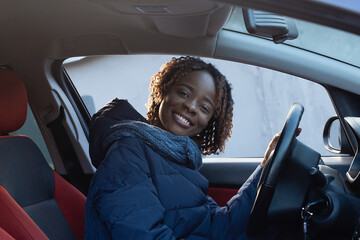 beautiful and happy African American in the car
