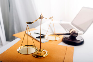 Justice and law concept.Male judge in a courtroom with the gavel, working with, computer and docking keyboard, eyeglasses, on table in morning light