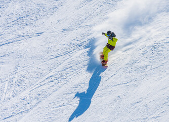 Snowboarder on the slopes of the Ski resort GrandVallira. Pyrenees mountains. Andorra.
