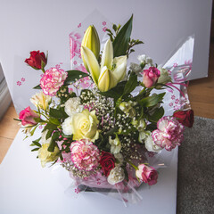 A spring flower arrangement with naomi roses and chrysanthemums.