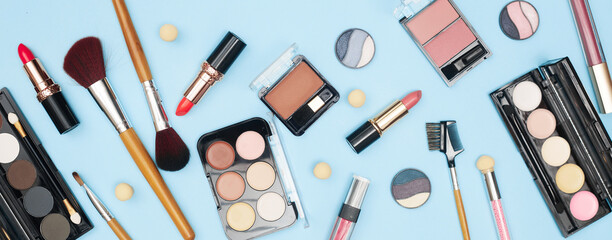 set of professional cosmetics, makeup tools and accessories on blue background, beauty, fashion, shopping concept, flat la