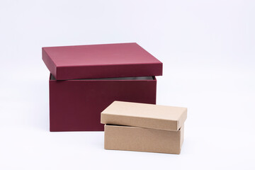 Burgundy packing box and brown cardboard box isolated on white