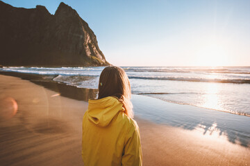 Woman walking on Kvalvika beach in Norway travel solo lifestyle active vacations outdoor scandinavian journey weekend getaway