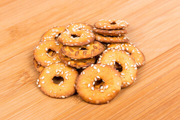 Pile of salty round pretzel pieces isolated over wood