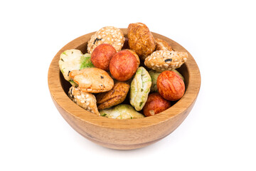Fototapeta premium Green red and orange oriental snack mix in a bowl isolated over white