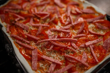 fresh pizza on a baking sheet