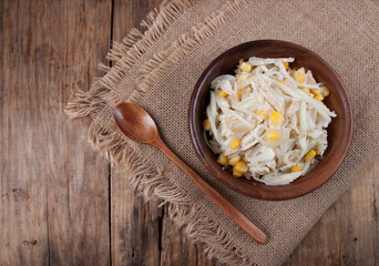 Homemade rustic salad with white radish in wooden bowl