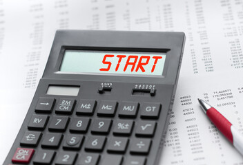 A calculator with the inscription start . Business profit concept