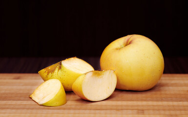 Naklejka na ściany i meble Whole and cut-up apples on cutting board