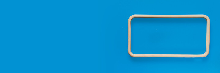 white plastic frame on blue background, place for ad text, Images with Copy Space